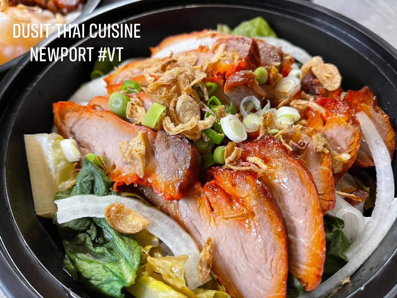 a close-up of a bowl of noodles with meat and vegetables